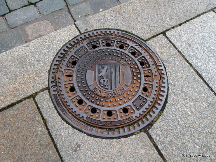 Manhole cover in Dresden showing the emblem of the city