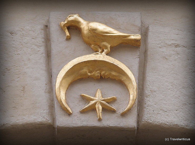 House sign with a moon showing a face